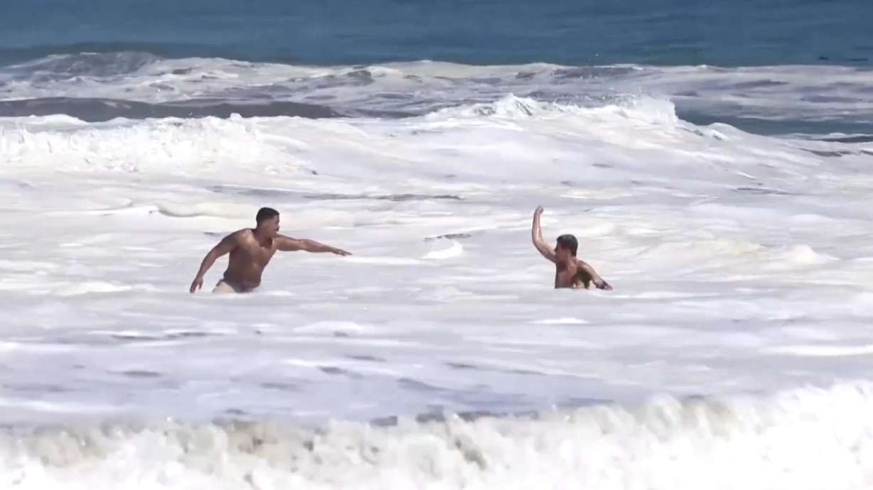 A 16-year-old lifeguard in California rushed into waves double his height to rescue a drowning 10-year-old boy.