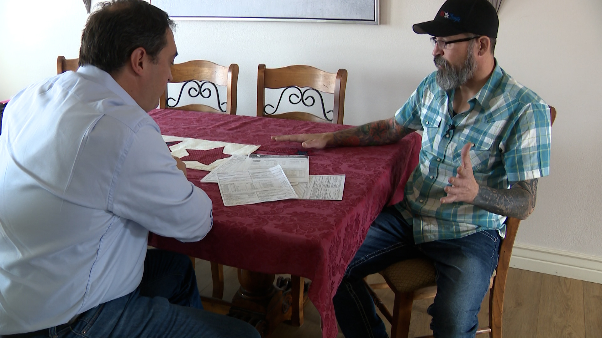 Brandon Peterson shows KSL's Matt Gephardt paperwork from Affordable Dentures and Implants regarding his dentures.
