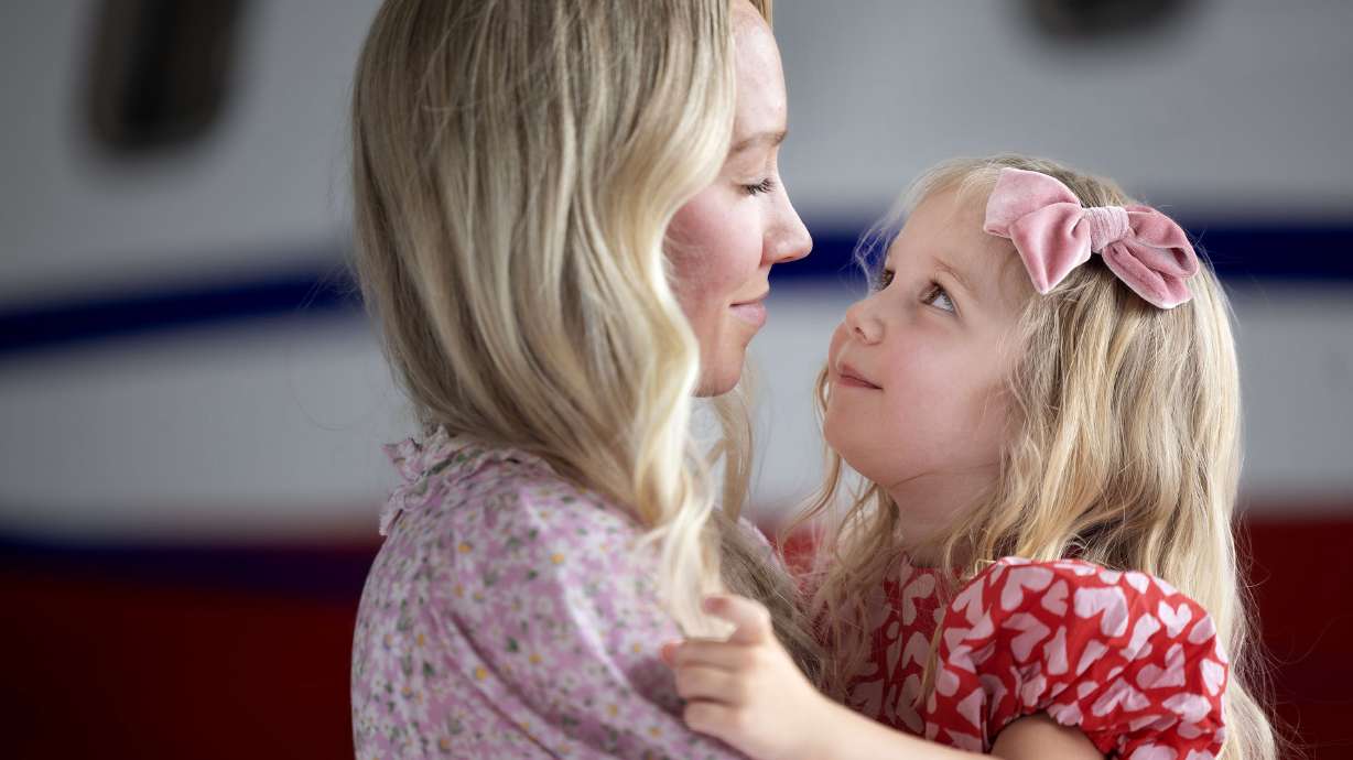 Ellie Santiago and her daughter, Estelle, 4, look at each other at the Intermountain Health Flight & Ambulance hangar in Salt Lake City on Wednesday. Estelle was flown by medical jet from Uruguay to Utah for lifesaving medical treatment.