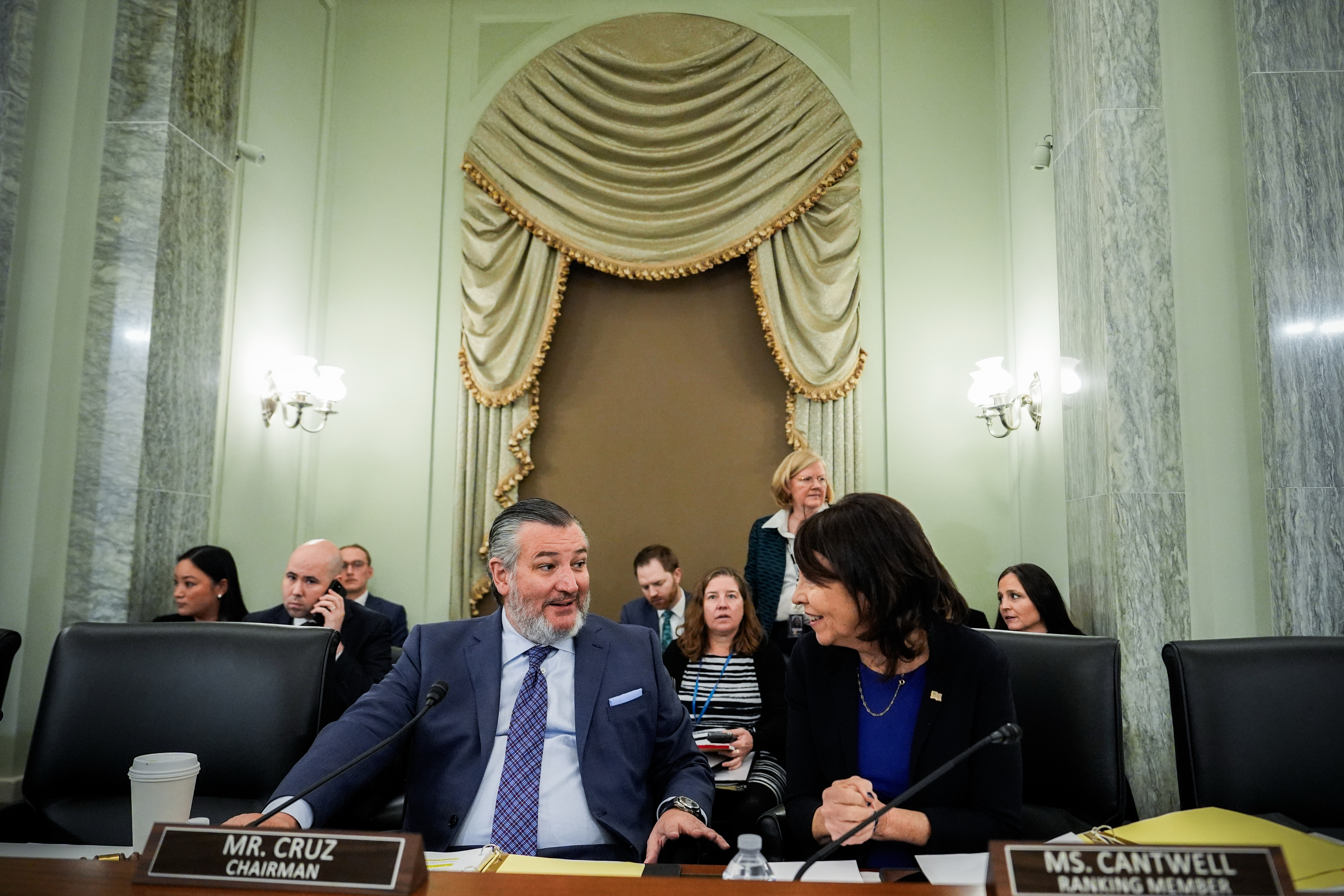 FILE - Sen. Ted Cruz, R-Texas, left, chairman of the Senate Commerce, Science and Transportation Committee, speaks with Sen. Maria Cantwell, D-Wash., right, before a hearing Wednesday, Nov. 19, 2025, on Capitol Hill in Washington. 