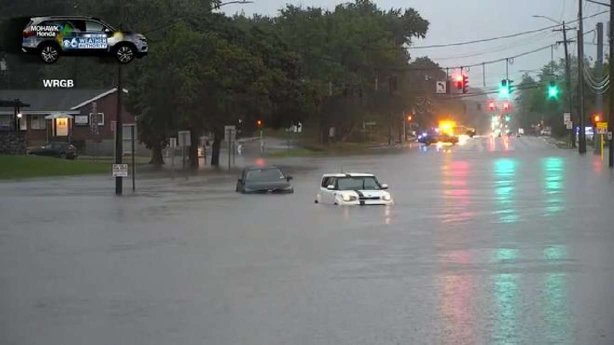 Cars are pictured on a flooded road in Guilderland, New York.