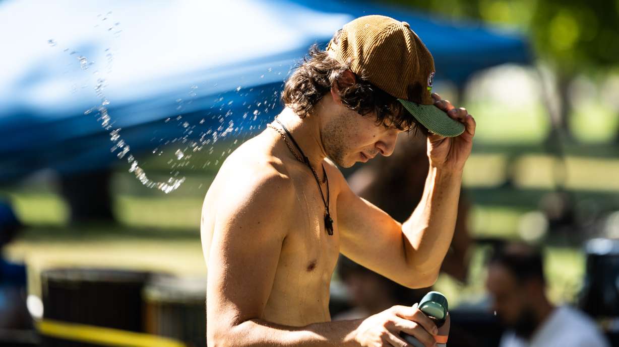A man dumps a water-filled hat on his head during a citywide heat advisory at Liberty Park in Salt Lake City on July 26. Utah experienced its warmest summer on record despite above-normal precipitation, per federal climate data released on Wednesday.