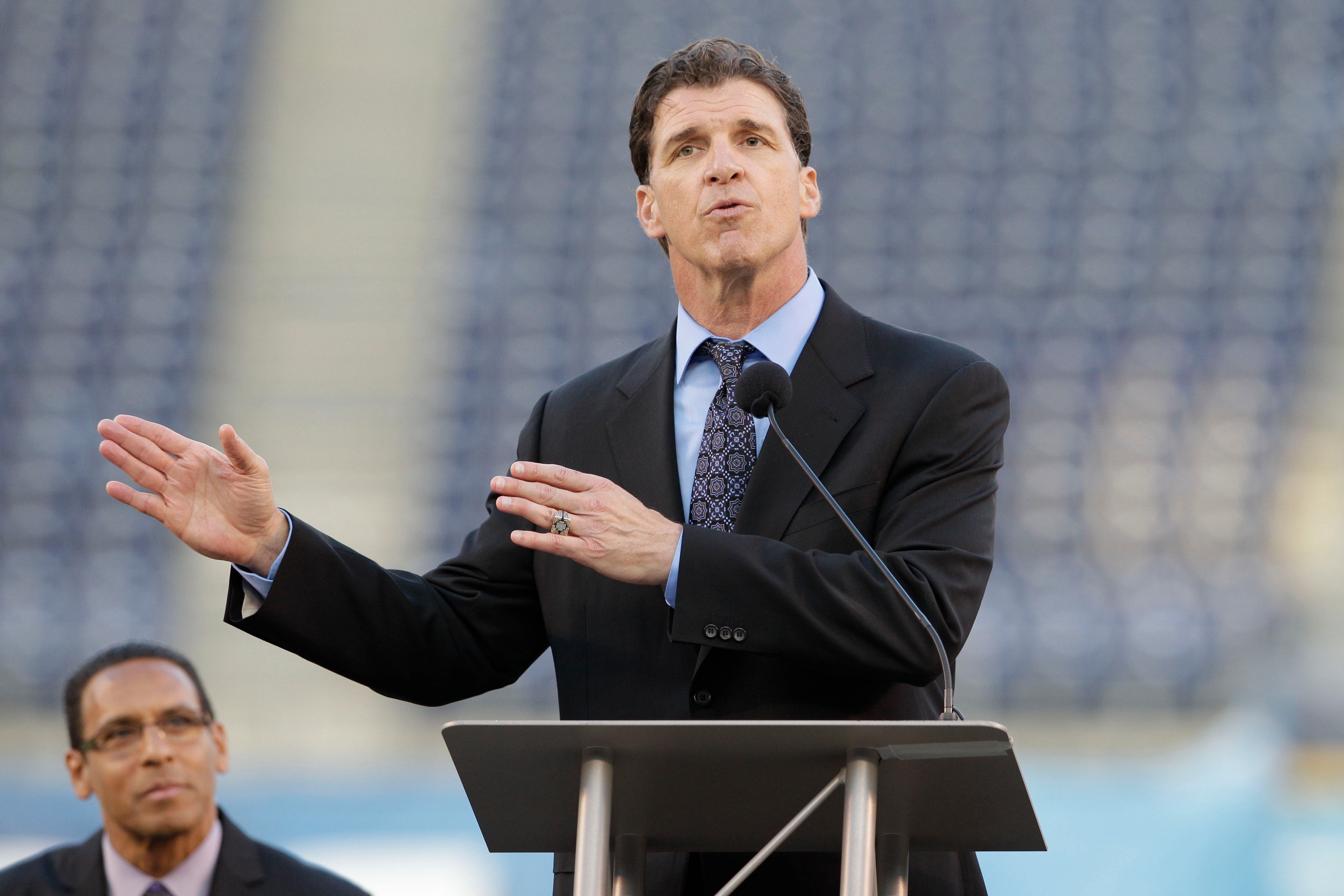FILE - Former San Diego Chargers linebacker Billy Ray Smith Jr. gestures during a public memorial service for football player Junior Seau at Qualcomm Stadium, May 11, 2012, in San Diego. 