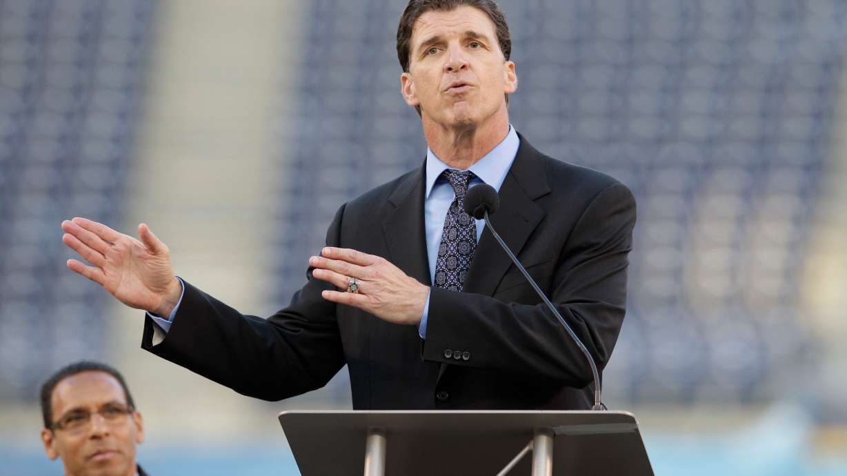 FILE - Former San Diego Chargers linebacker Billy Ray Smith Jr. gestures during a public memorial service for football player Junior Seau at Qualcomm Stadium, May 11, 2012, in San Diego.