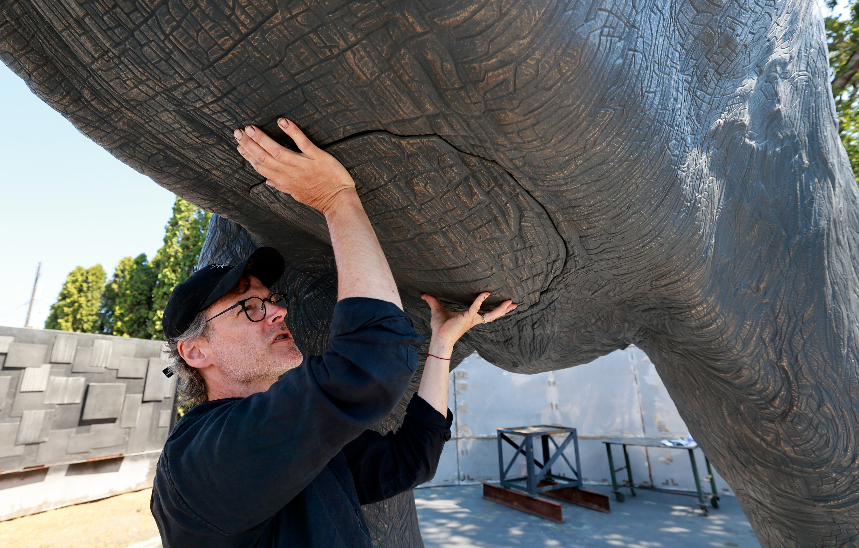 Matthew Gray Palmer shows where he will weld the final piece of an elephant's belly onto Yumi, a roughly 18,000-pound bronze elephant Palmer has been sculpting and building for seven years, at Metal Art Foundry in Lehi on Thursday.