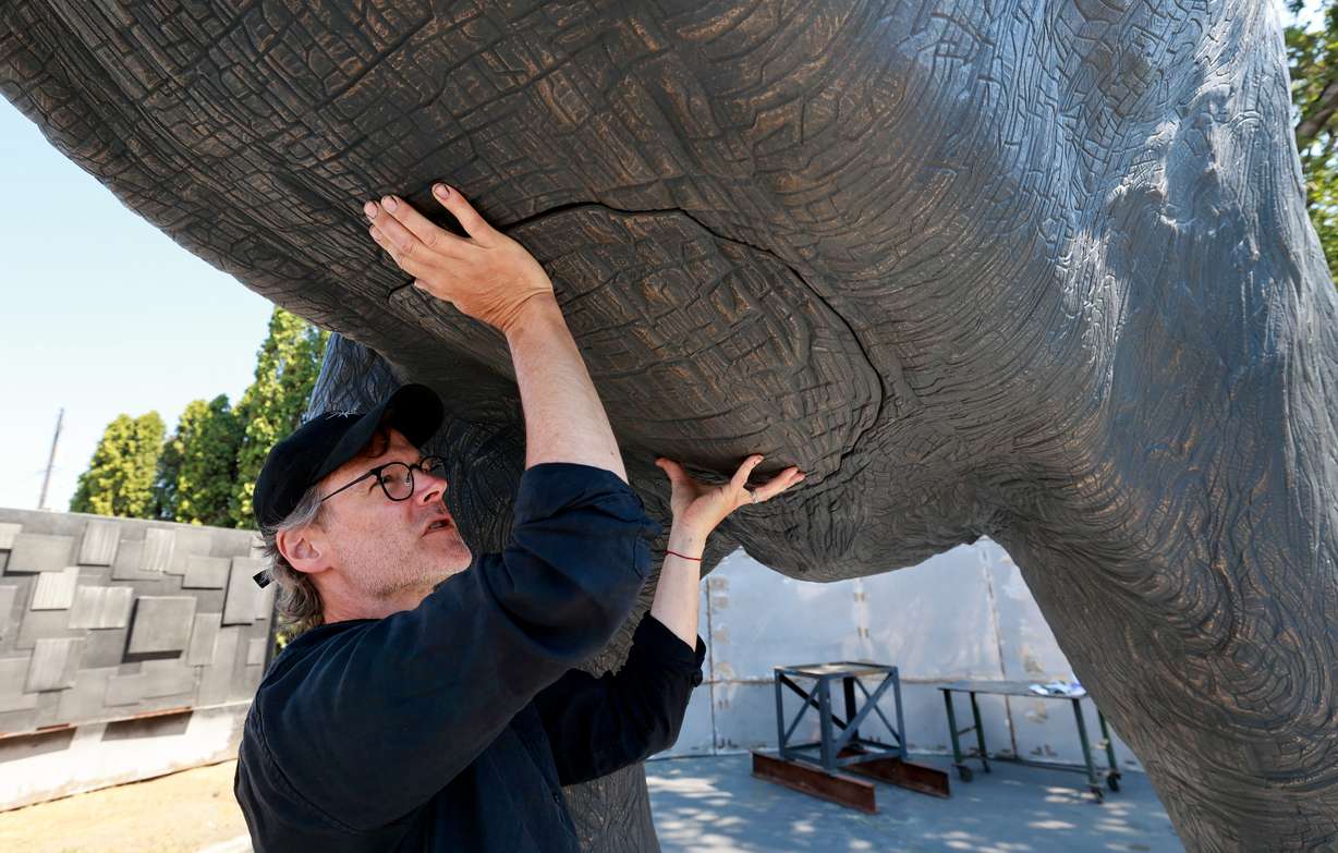 Matthew Gray Palmer shows where he will weld the final piece of an elephant's belly onto Yumi, a roughly 18,000-pound bronze elephant Palmer has been sculpting and building for seven years, at Metal Art Foundry in Lehi on Thursday.