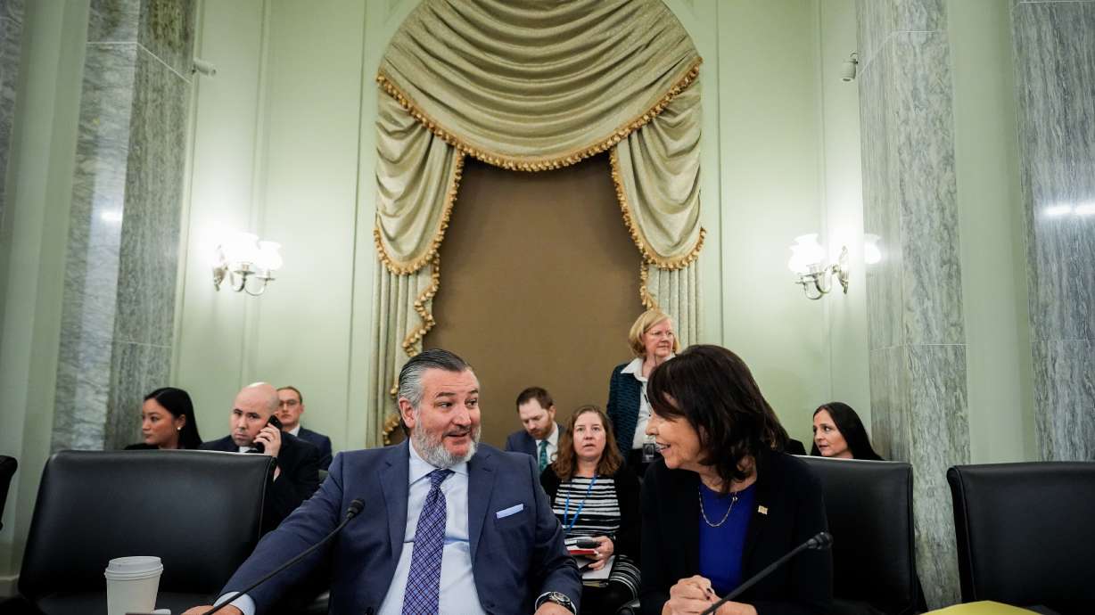 FILE - Sen. Ted Cruz, R-Texas, left, chairman of the Senate Commerce, Science and Transportation Committee, speaks with Sen. Maria Cantwell, D-Wash., right, before a hearing Wednesday, Nov. 19, 2025, on Capitol Hill in Washington.