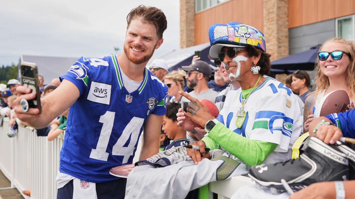 Seattle Seahawks quarterback Sam Darnold takes a selfie during the NFL football team's training camp, Sunday, July 26, 2026, in Renton, Wash.