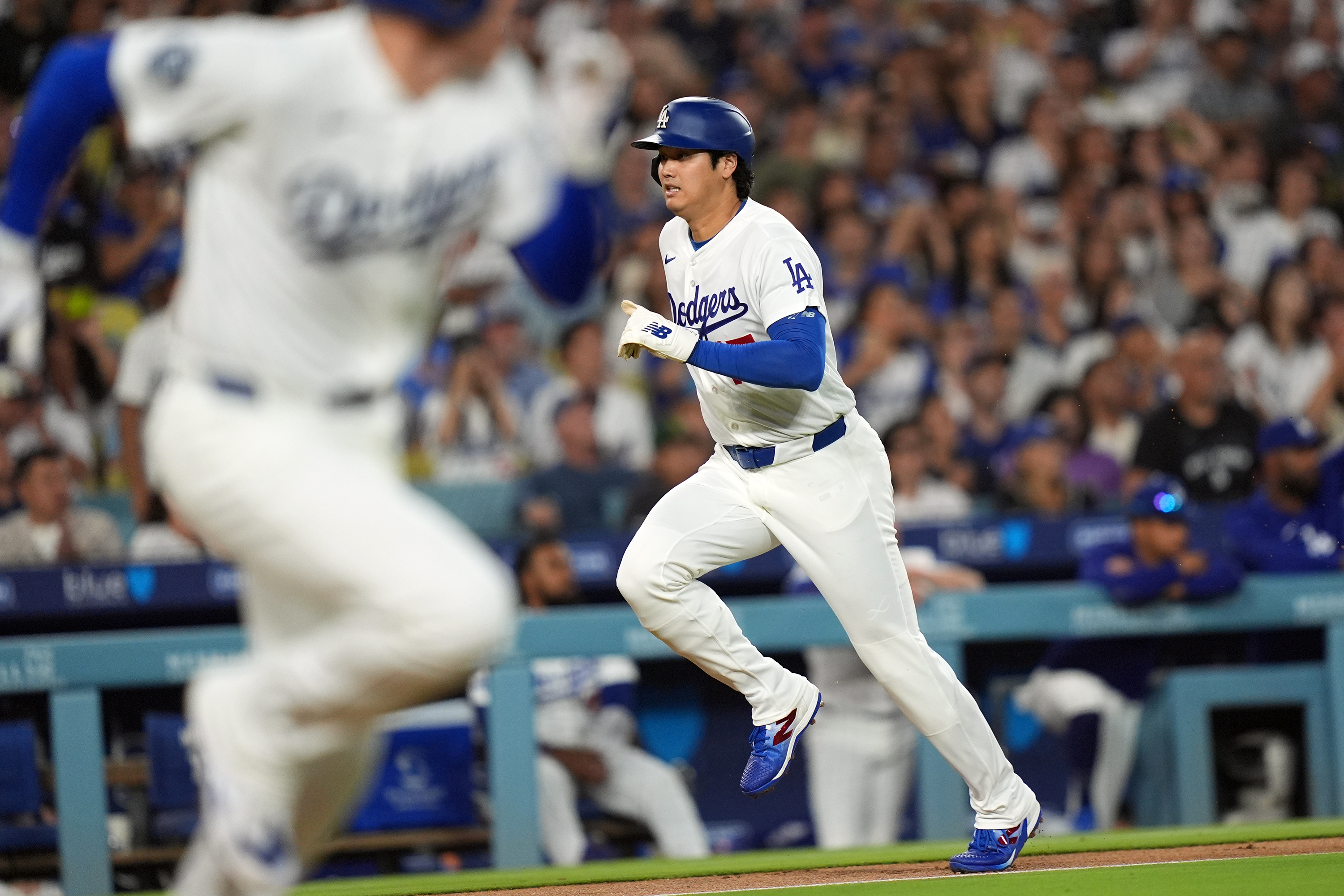 Los Angeles Dodgers' Shohei Ohtani (17) scores on an infield hit by Freddie Freeman (5) against the Seattle Mariners during the third inning of a baseball game Wednesday, July 29, 2026, in Los Angeles. 