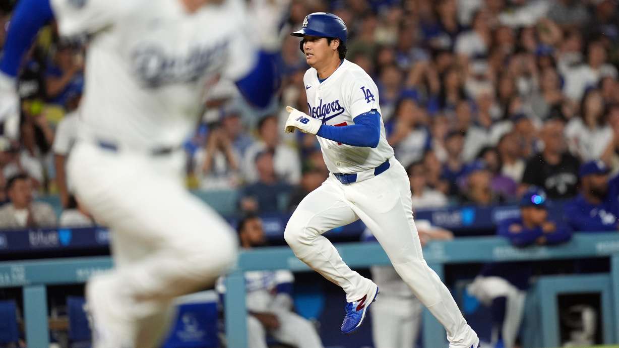 Los Angeles Dodgers' Shohei Ohtani (17) scores on an infield hit by Freddie Freeman (5) against the Seattle Mariners during the third inning of a baseball game Wednesday, July 29, 2026, in Los Angeles.
