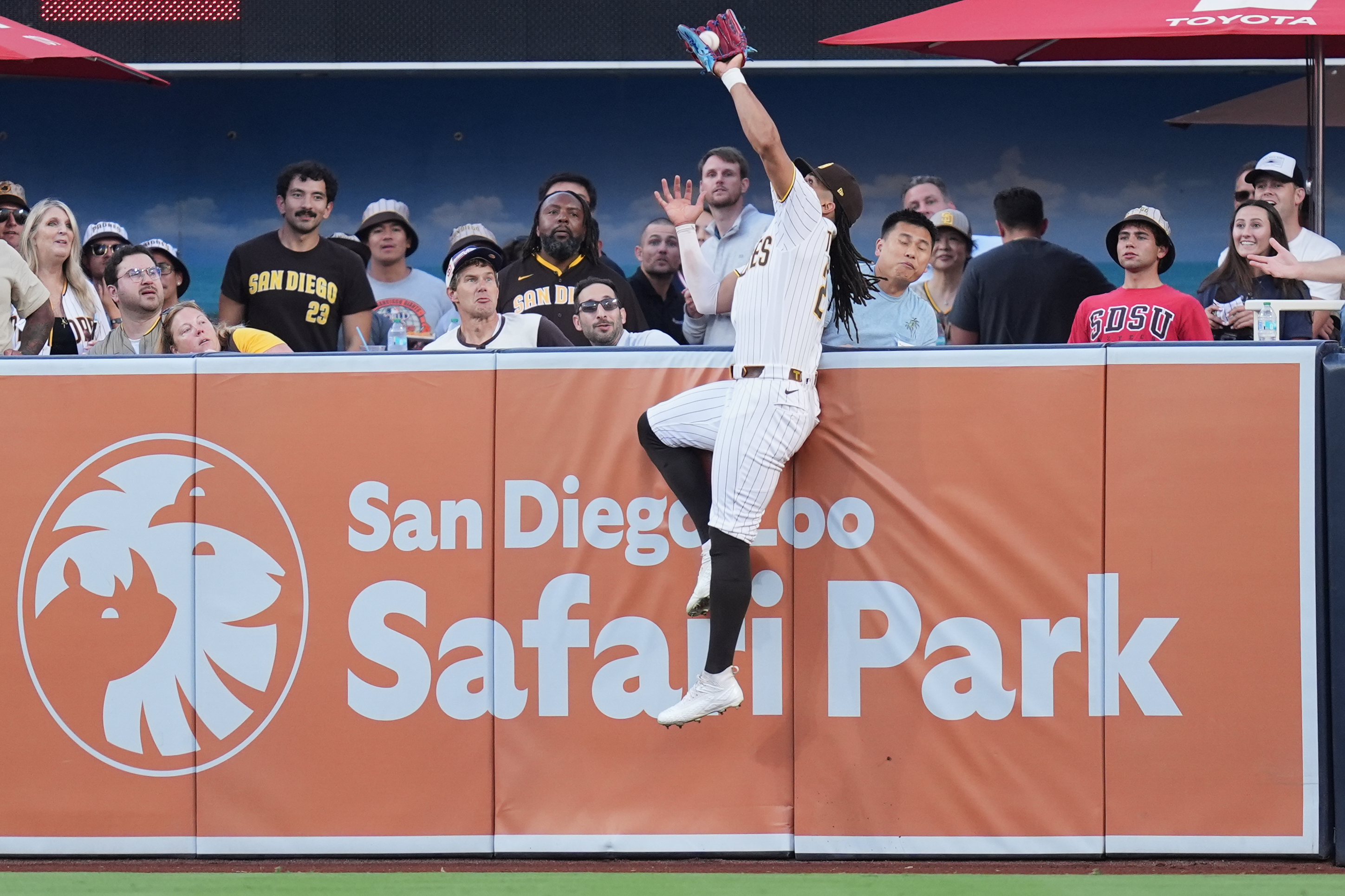 San Diego Padres right fielder Fernando Tatis Jr. makes the catch above the wall for the out on a sacrifice fly by San Francisco Giants' Rafael Devers during the first inning of a baseball game Thursday, July 30, 2026, in San Diego. 