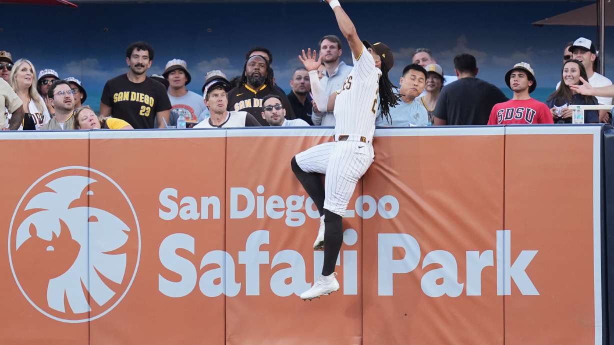 San Diego Padres right fielder Fernando Tatis Jr. makes the catch above the wall for the out on a sacrifice fly by San Francisco Giants' Rafael Devers during the first inning of a baseball game Thursday, July 30, 2026, in San Diego.