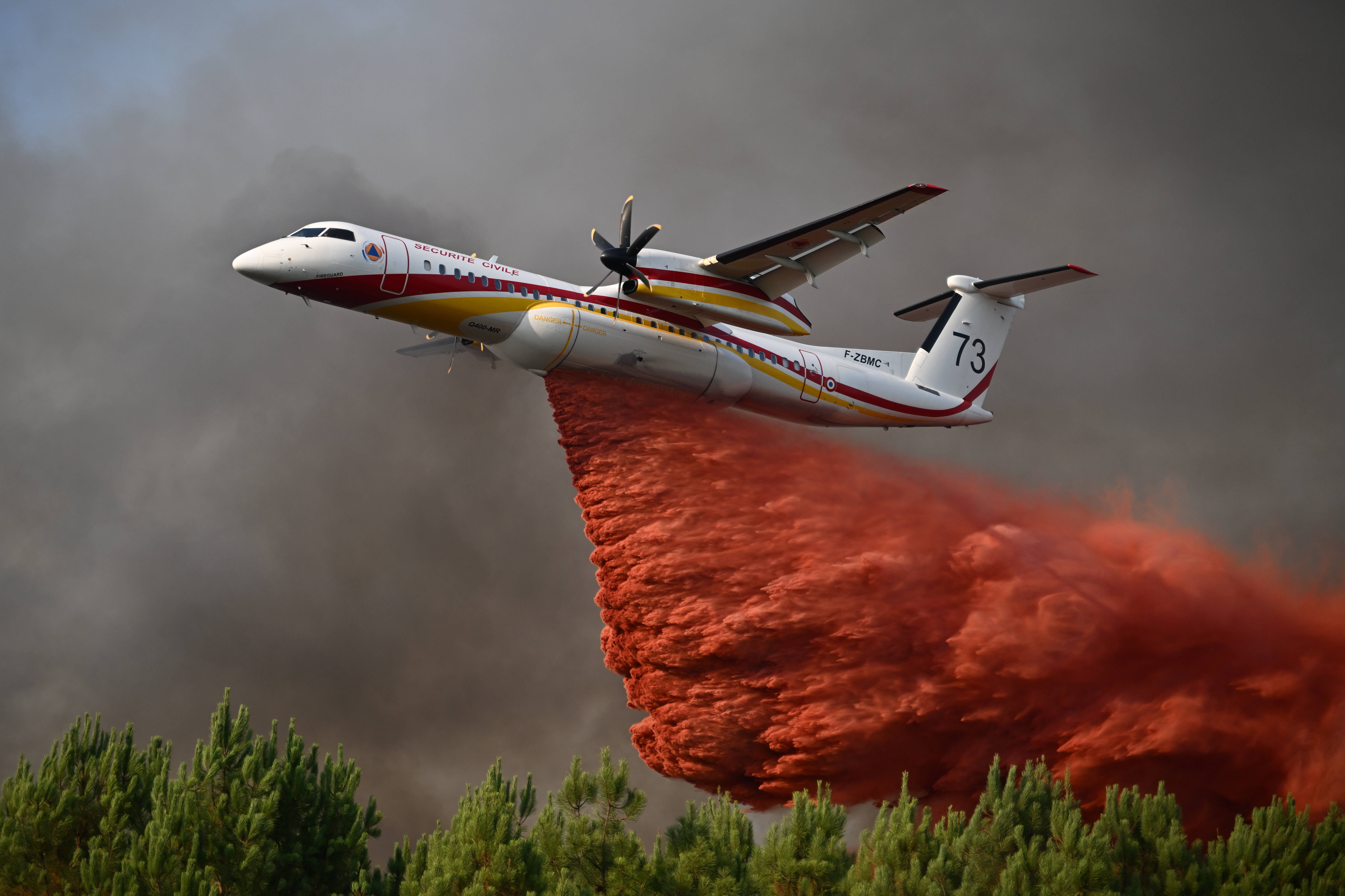 A plane releases fire retardant as it flies over a forest near Blagon, during wildfires in southwestern France, Wednesday.