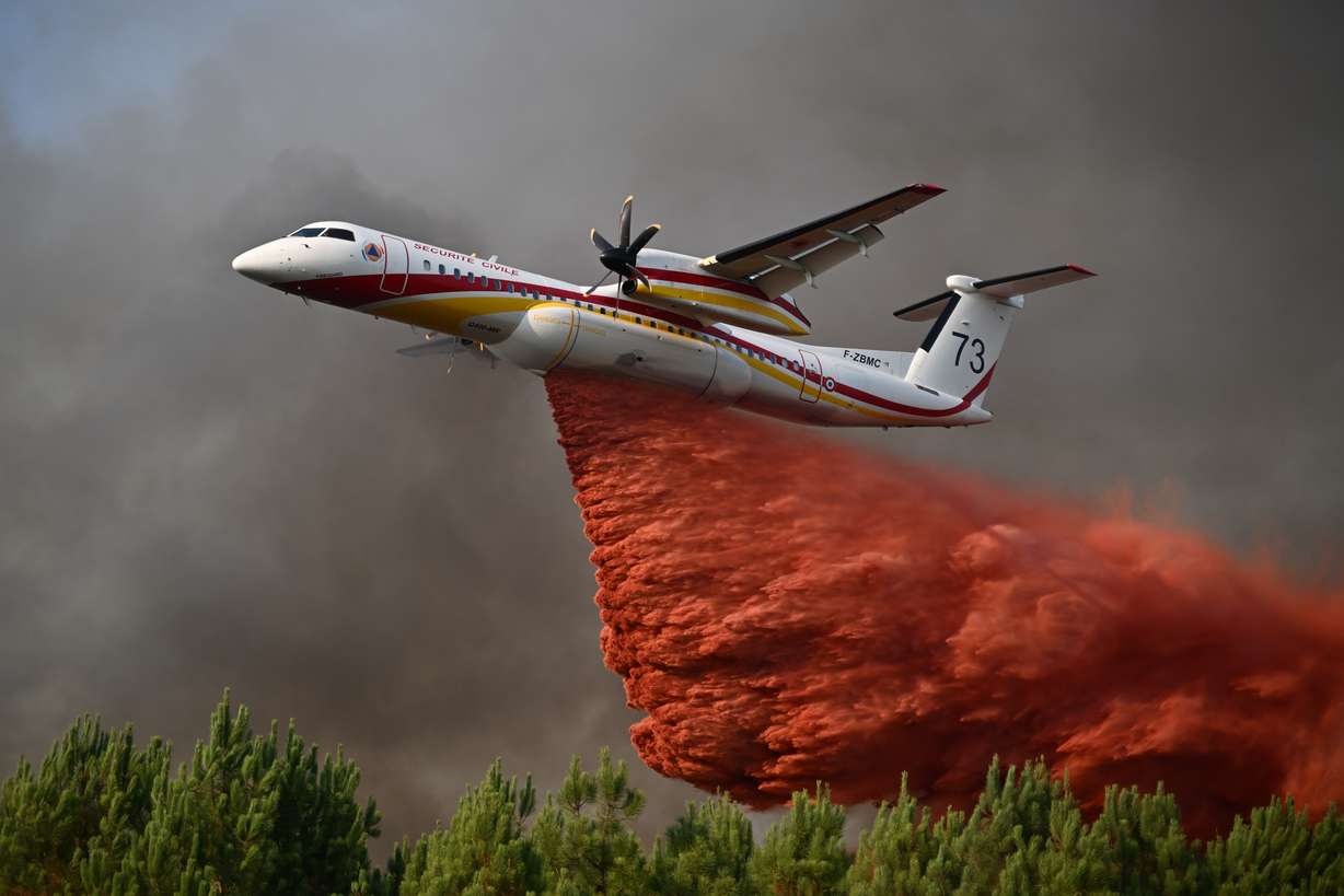 A plane releases fire retardant as it flies over a forest near Blagon, during wildfires in southwestern France, Wednesday.