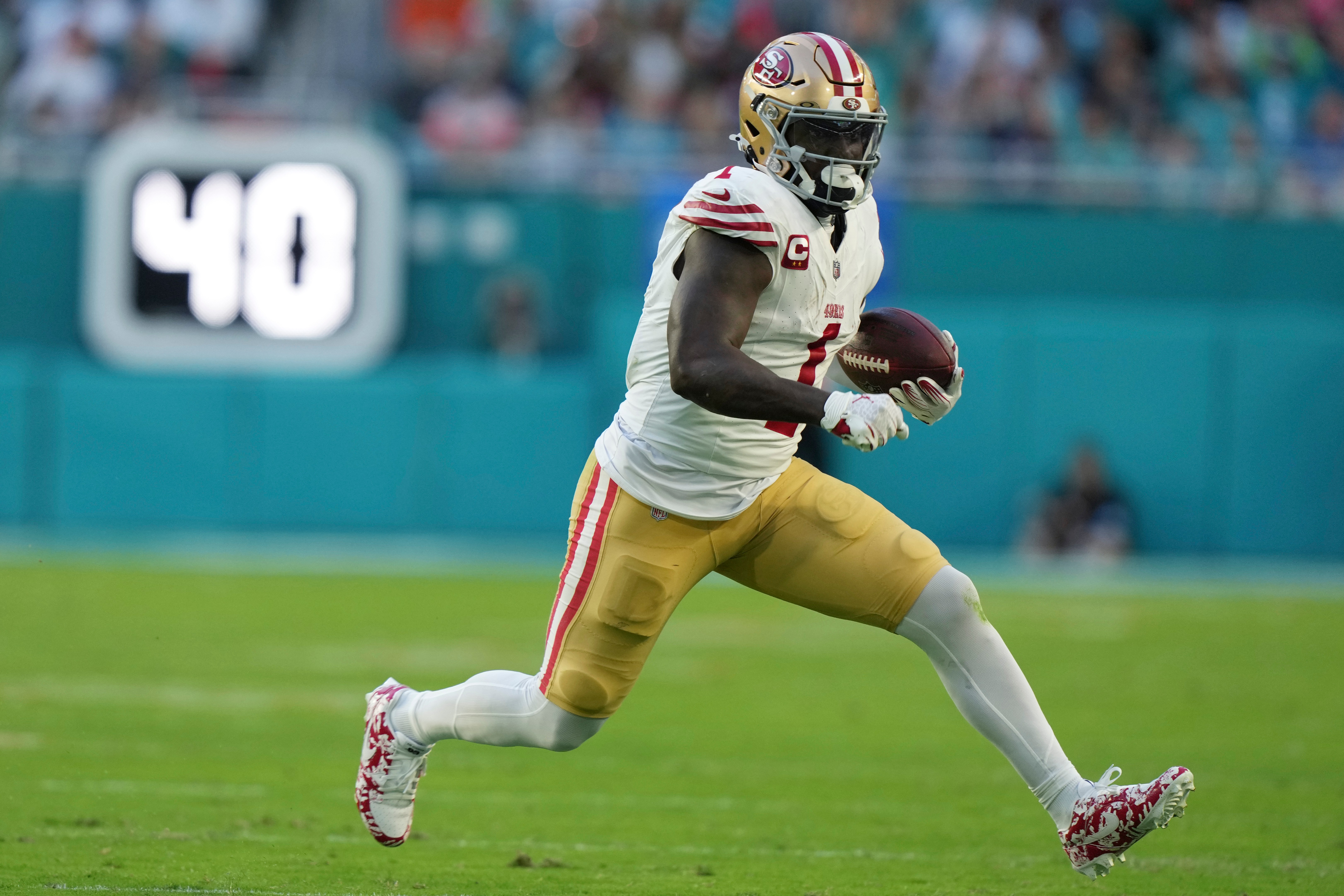 FILE - San Francisco 49ers wide receiver Deebo Samuel Sr. (1) runs for a first down during the first half of an NFL football game against the Miami Dolphins, Dec. 22, 2024, in Miami Gardens, Fla. 