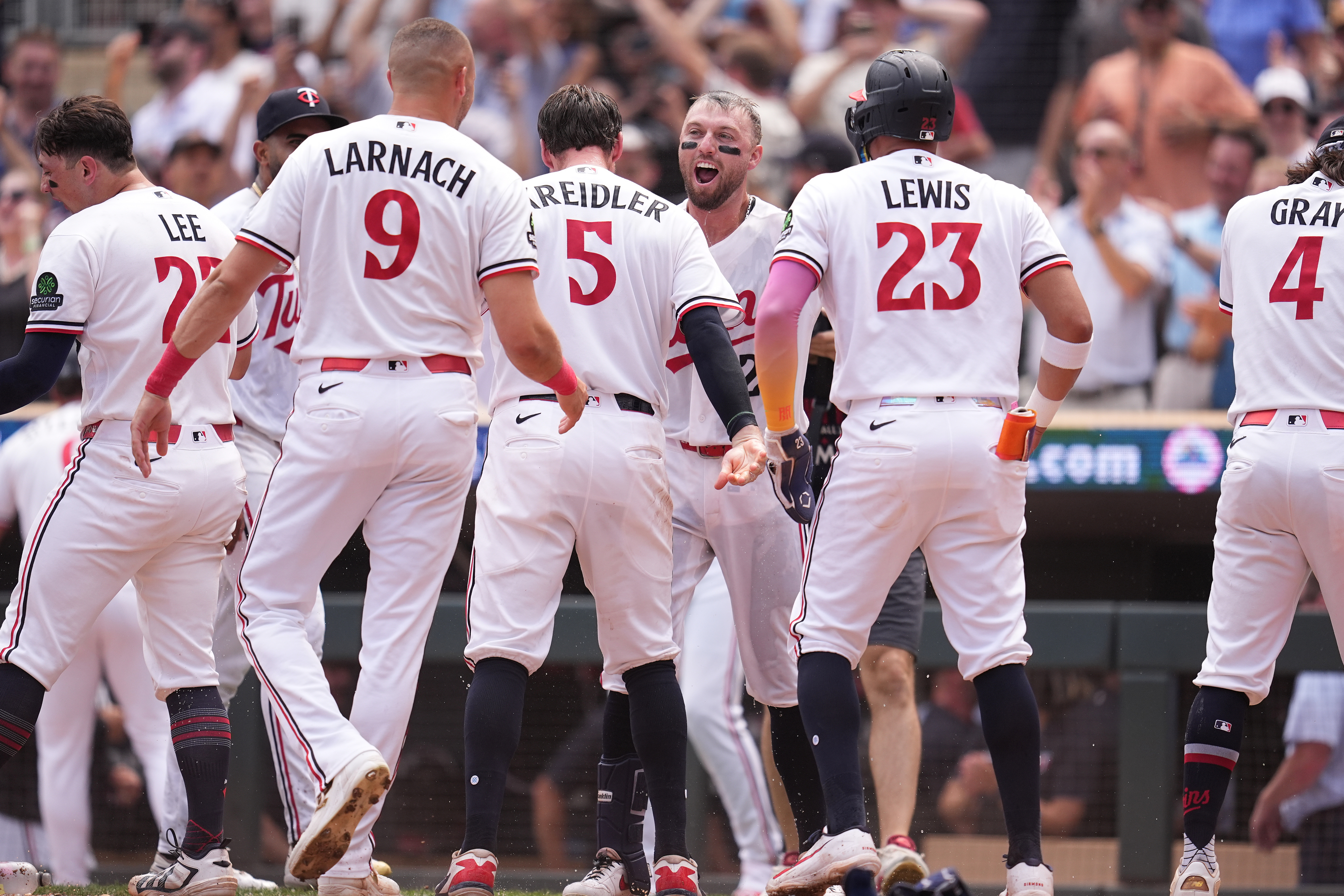Minnesota Twins' Kody Clemens, back, middle, celebrates with teammates after hitting a walk-off grand slam during the ninth inning of a baseball game against the Kansas City Royals Thursday, July 30, 2026, in Minneapolis. 