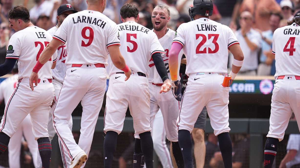 Minnesota Twins' Kody Clemens, back, middle, celebrates with teammates after hitting a walk-off grand slam during the ninth inning of a baseball game against the Kansas City Royals Thursday, July 30, 2026, in Minneapolis.