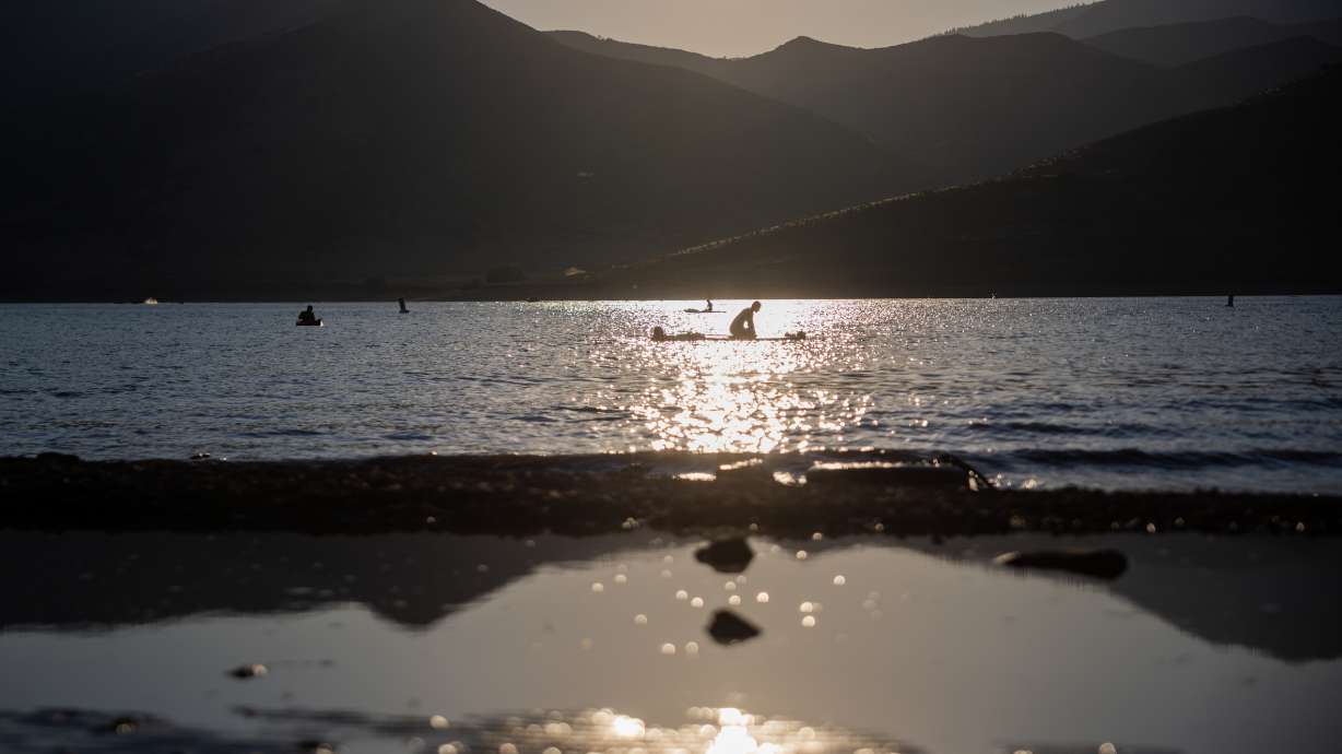 People paddle in Deer Creek Reservoir in Wasatch County on Thursday. Utah's reservoir system tumbled in July, but monsoons have benefitted the state's mountain soils.