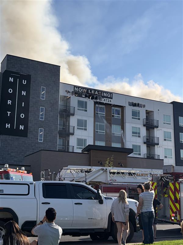 Smoke rises from the North Union apartment building in Midvale on Friday.