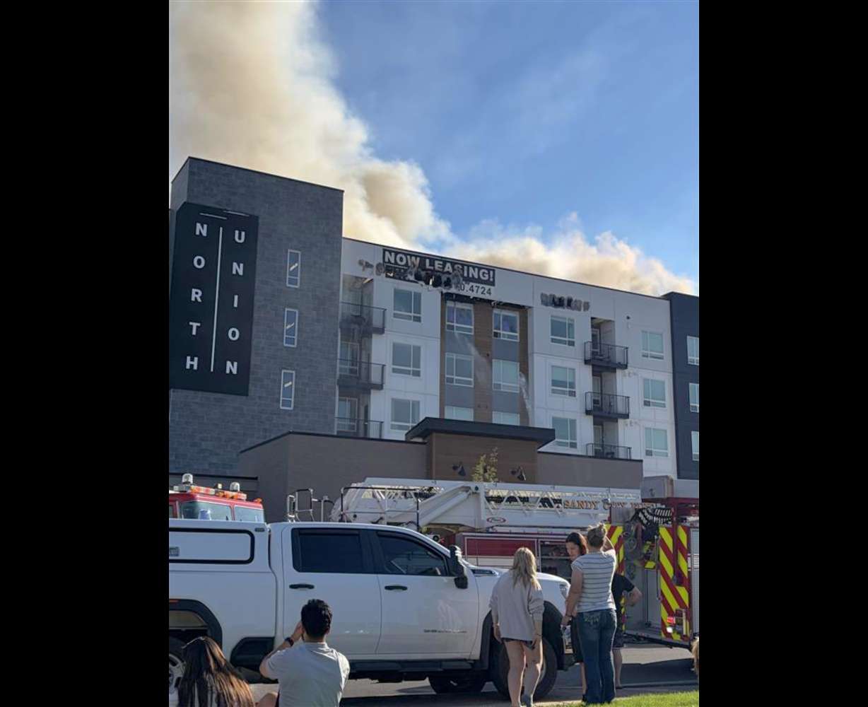 Smoke rises from the North Union apartment building in Midvale on Friday.