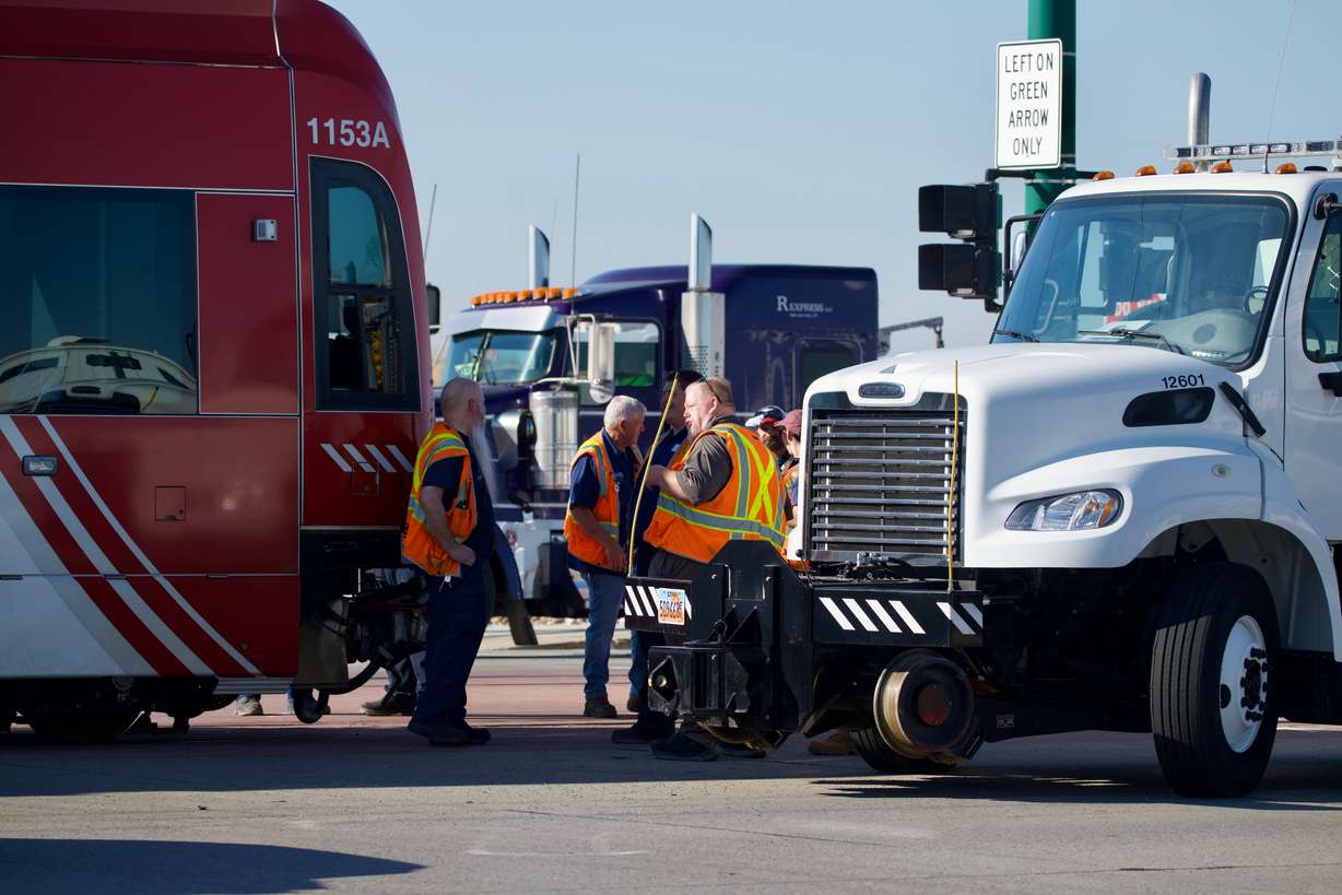 Crews work to clear debris from a crash that occurred Friday between a TRAX Green Line train and a car.
