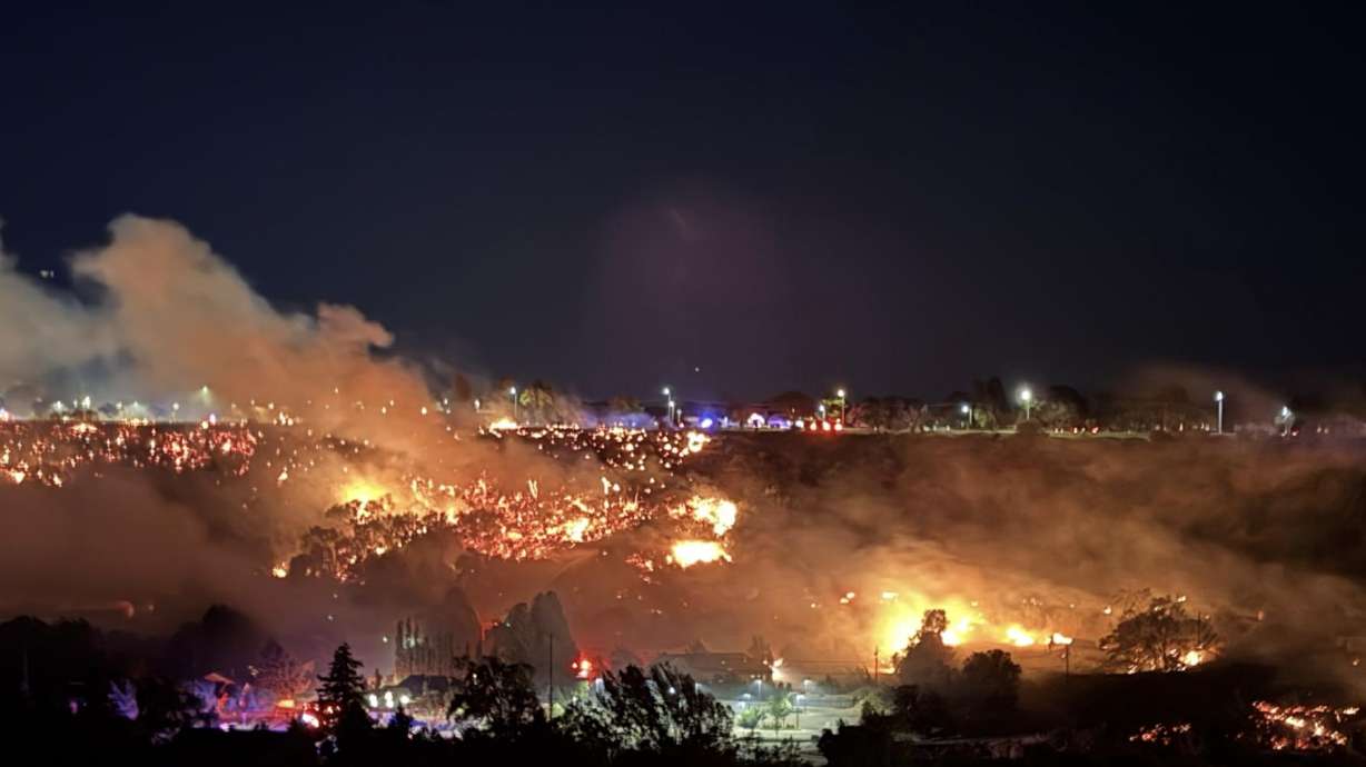 A fire burns in Logan early Saturday, prompting officials to expand a mandatory evacuation zone as emergency crews responded.