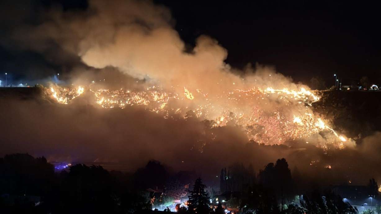 A fire burns in Logan early Saturday, prompting officials to expand a mandatory evacuation zone as emergency crews responded.