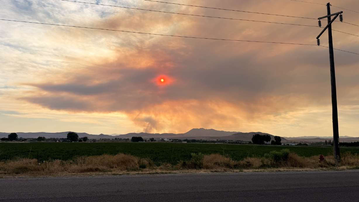The Johnson Canyon Fire is pictured from Smithfield on Saturday. New wildfires have been reported over the last 24 hours as temperatures across Utah soar. The National Weather Service issued an Extreme Heat Warning for parts of Utah until Sunday night.