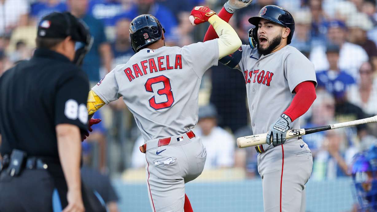 Boston Red Sox's Ceddanne Rafaela (3), left, is greeted by Boston Red Sox's Wilyer Abreu (52) after hitting a solo home run during the first inning of a baseball game against the Los Angeles Dodgers, Saturday, Aug. 1, 2026, in Los Angeles.