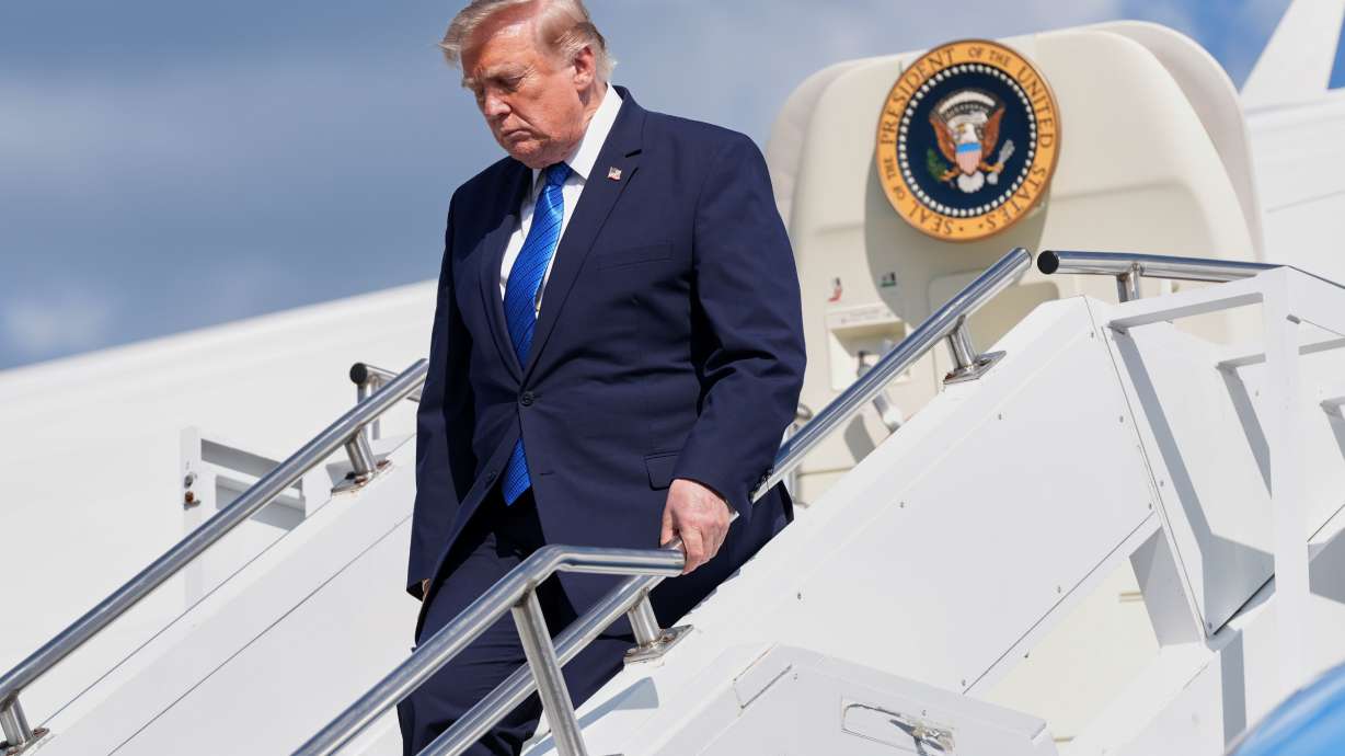 President Donald Trump exits Air Force One at Morristown Municipal Airport in Morristown, N.J., Friday after a trip to Camp David, the presidential retreat.