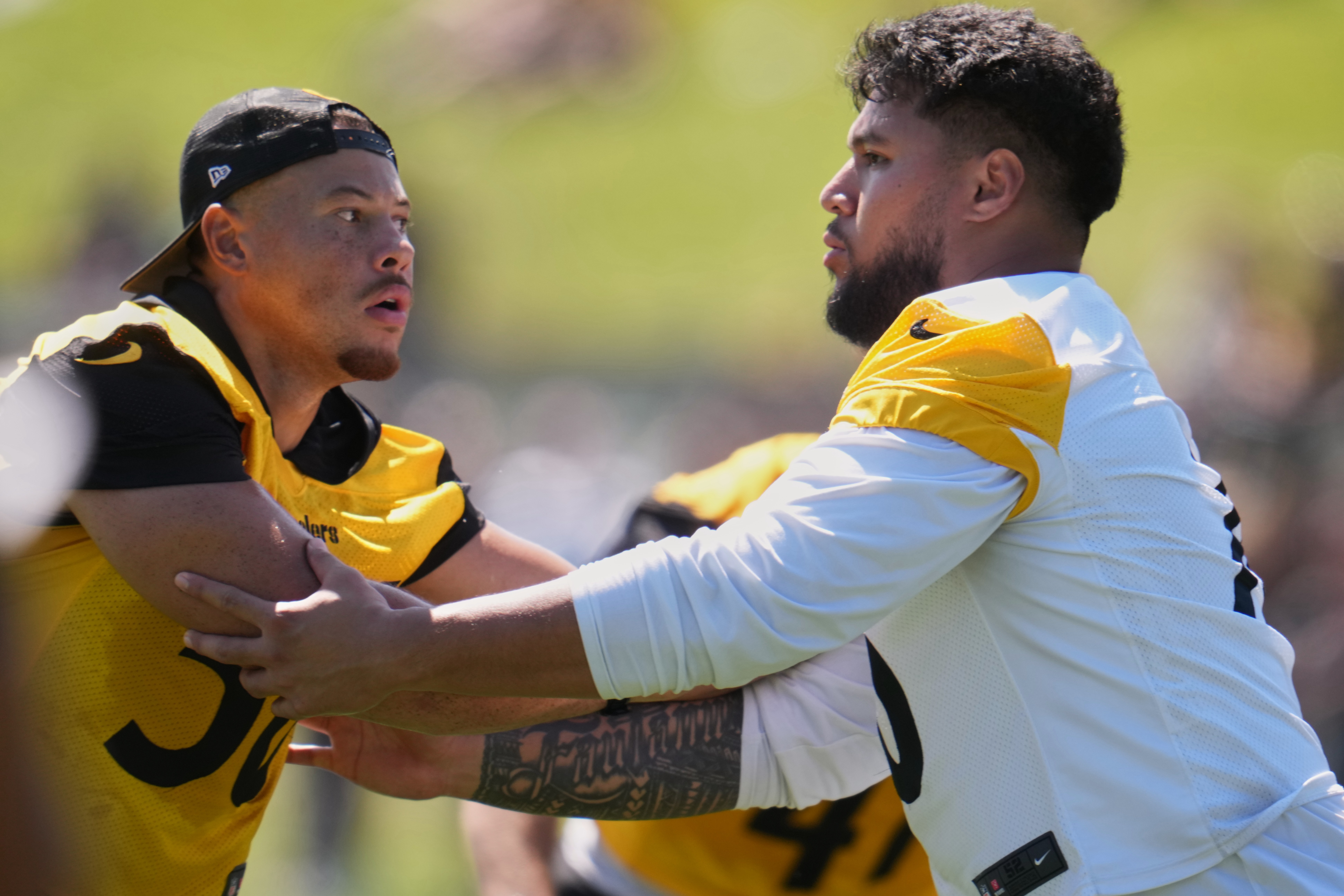 Pittsburgh Steelers linebacker Alex Highsmith (56), left, is blocked by offensive tackle Troy Fautanu during the team's NFL football training camp in Latrobe, Pa., on Friday, July 31, 2026.