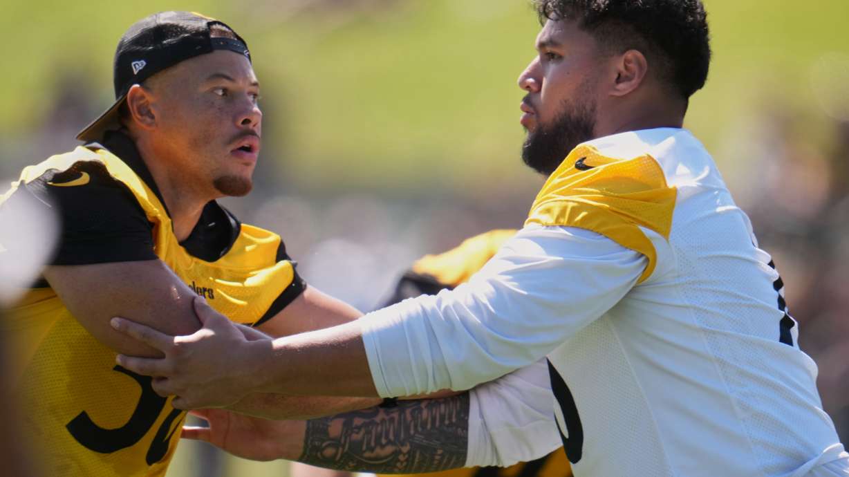 Pittsburgh Steelers linebacker Alex Highsmith (56), left, is blocked by offensive tackle Troy Fautanu during the team's NFL football training camp in Latrobe, Pa., on Friday, July 31, 2026.