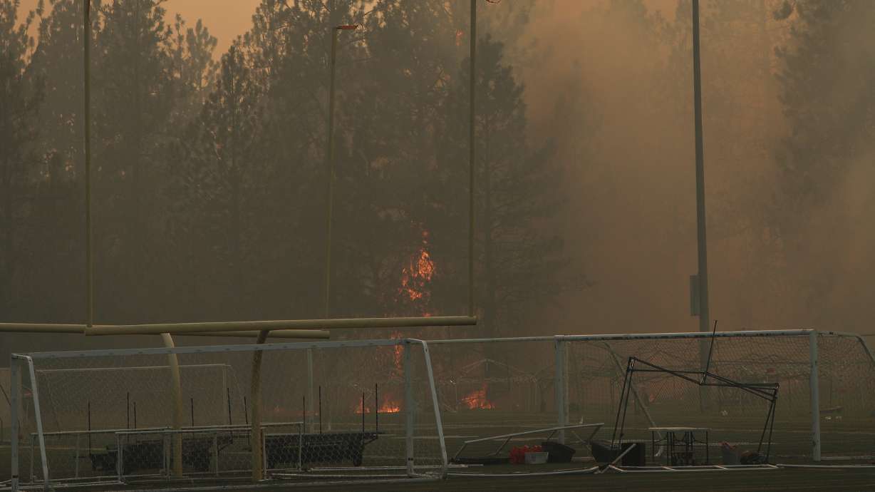 Old Trails Fire burns near Dwight Merkel Sports Complex on Saturday, in Spokane, Wash. About 5,000 homes have been evacuated and about 600 homes, businesses and other buildings have been destroyed by wildfires that remained uncontained Sunday in eastern Washington state, authorities said.