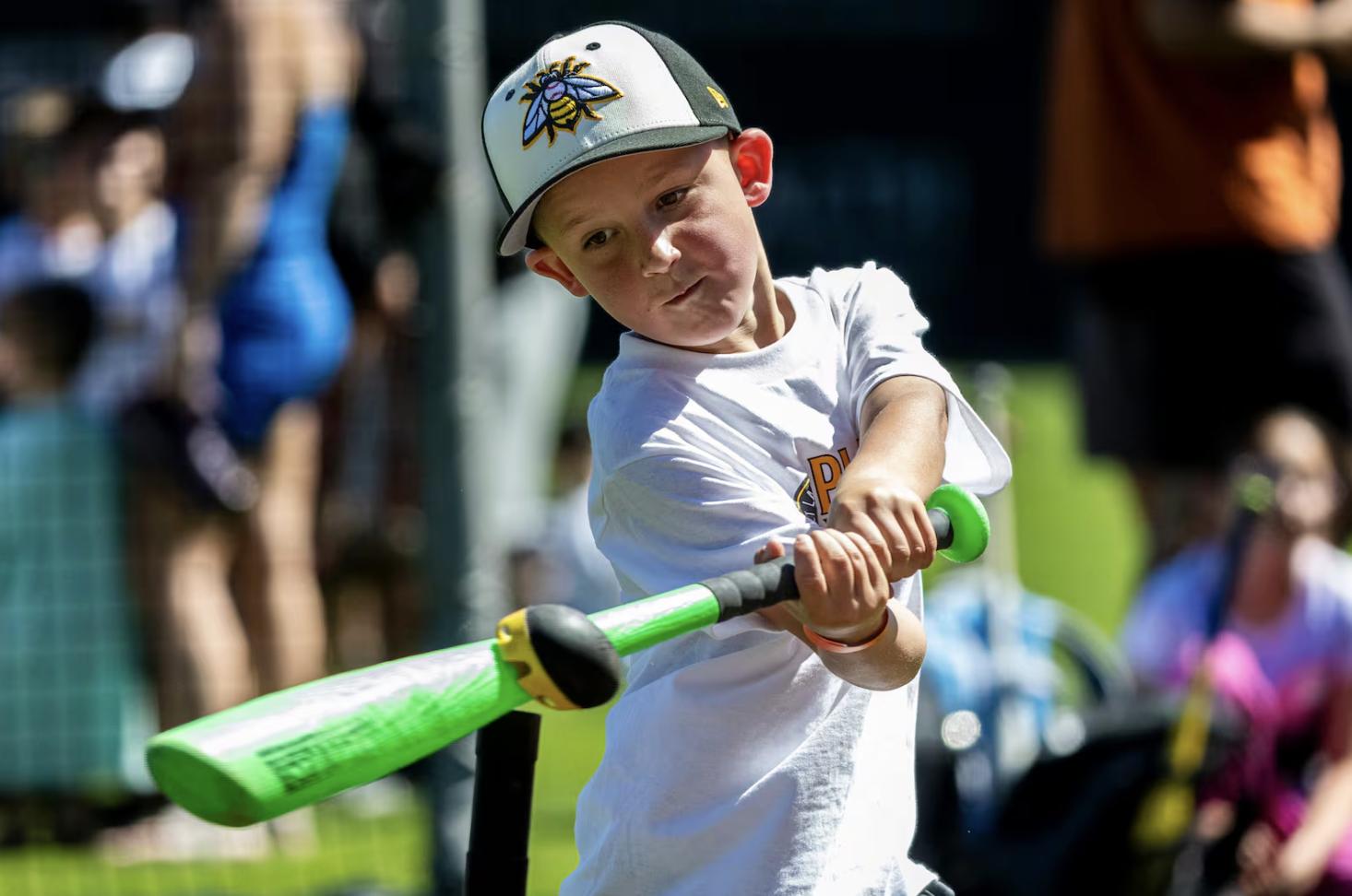 Steven Glasgow, 5, of Mapleton, connects with the ball as part of a T-ball activity during a kick-off event for Utah Youth Sports Giving Day held at The Ballpark at America First Square in South Jordan on June 5.