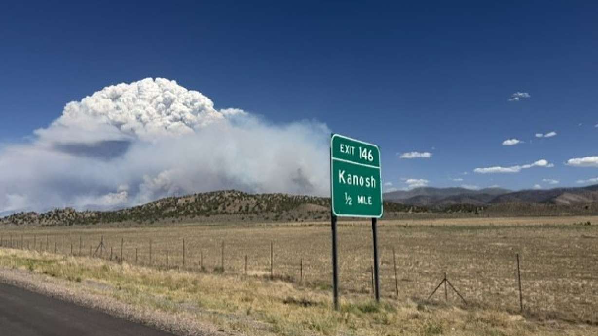 A picture shows a large plume of smoke due to the Widemouth 2 Fire, outside of Kanosh from I-15 on Sunday at 3:20 p.m.
