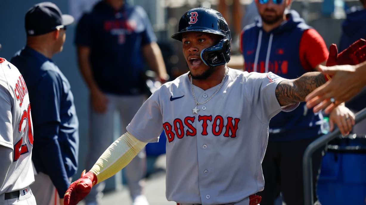 Boston Red Sox's Ceddanne Rafaela is greeted by teammates after scoring on a single hit by Sox's designated hitter Masataka Yoshida during the first inning of a baseball game, Sunday, Aug. 2, 2026, in Los Angeles.
