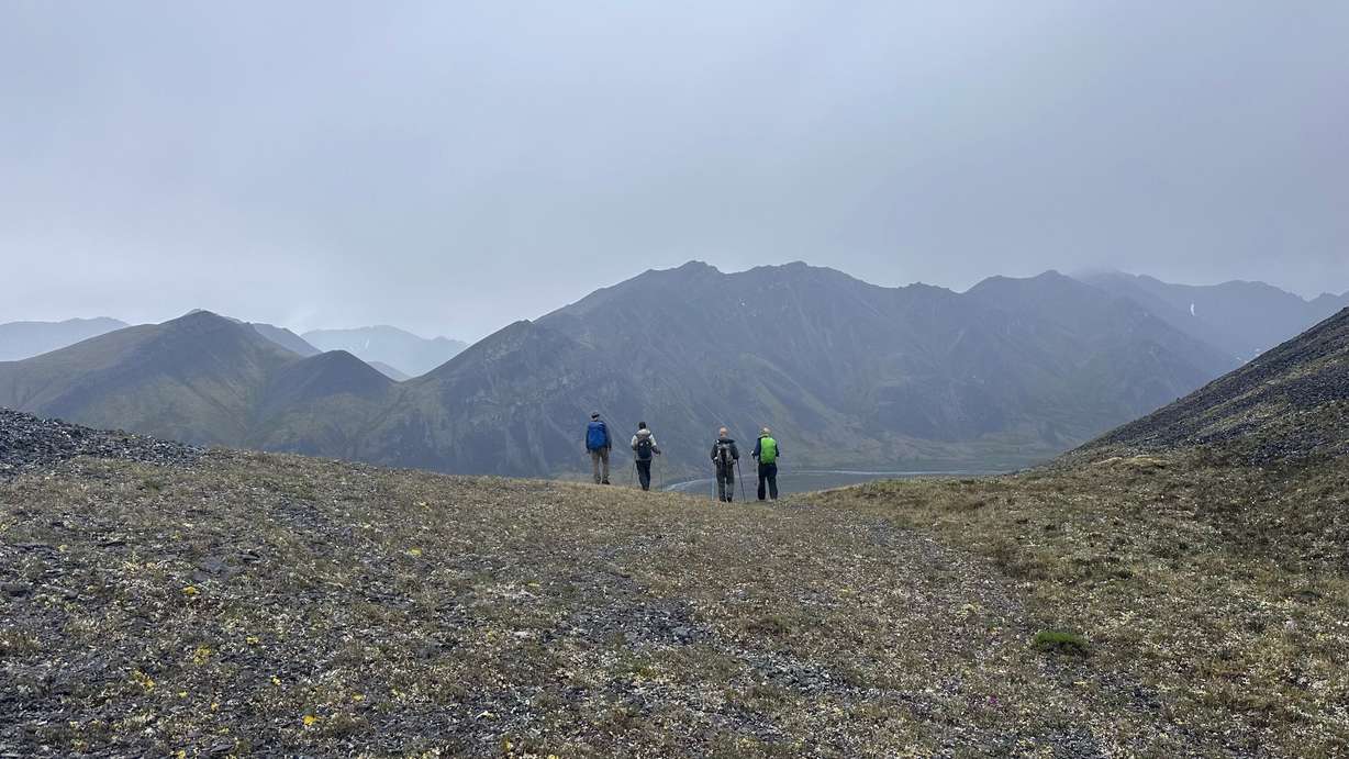 Minutes before finding the dall ram horn, a group of hikers, led by guide Jeffery “Country” Gillespie, left, takes a break on the saddle between two unnamed peaks in the Arctic National Wildlife Refuge in Alaska on June 30.