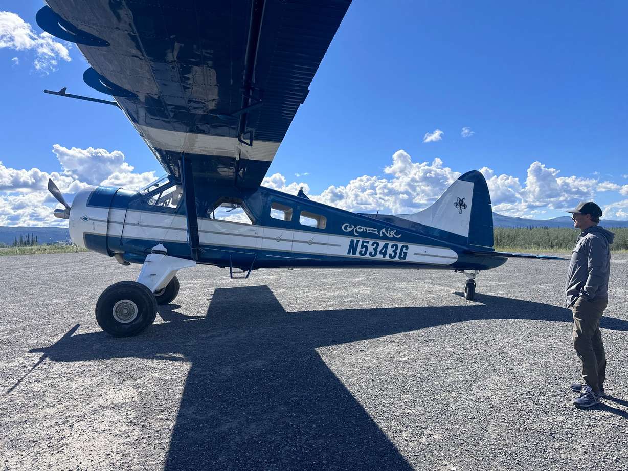 Chris Keyes, editor of Re:Public, says goodbye to one of Coyote Air’s bush planes on July 2, in Alaska’s Arctic Village after the flight to the 1002.