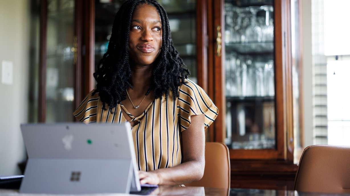 Faith Maeba, a student at Virginia Commonwealth University, poses for a portrait with her tablet at her home July 20, in Stafford, Va.