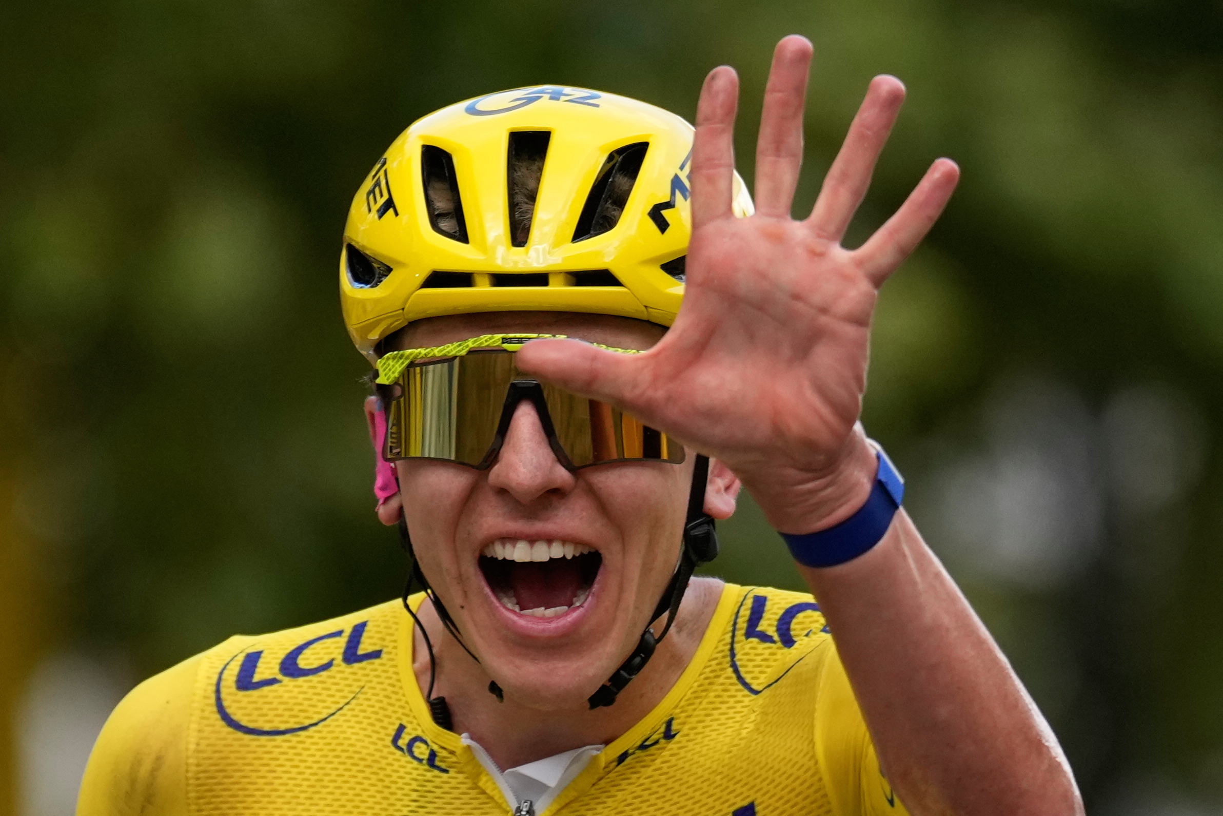 Slovenia's Tadej Pogacar, wearing the overall leader's yellow jersey, celebrates as he crosses the finish line of the last stage of the Tour de France cycling race with start and finish in Paris, Sunday, July 26, 2026. 