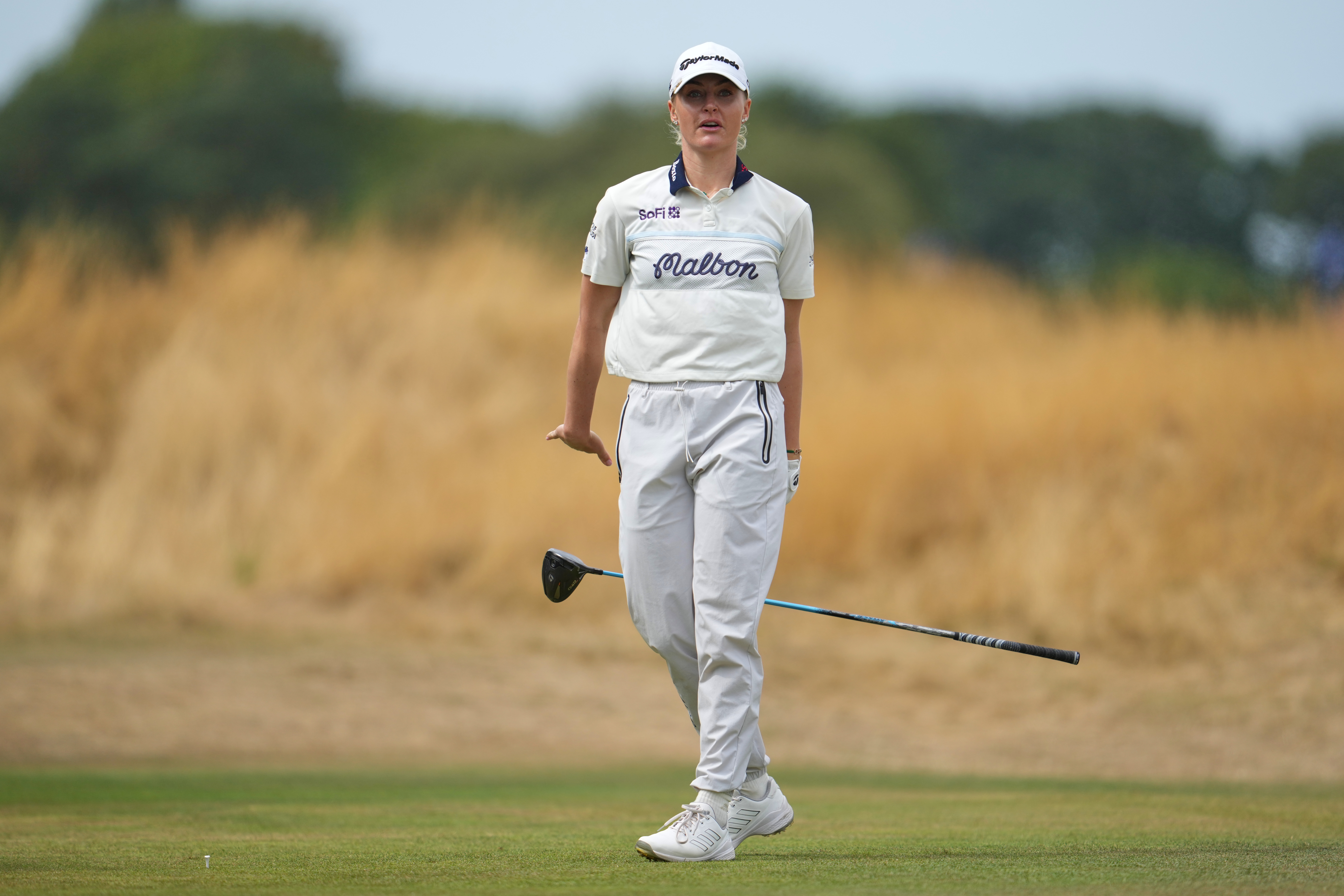 Charley Hull, of England, drops her club after driving off the 3rd tee during the fourth round of the Women's British Open golf championship in Lytham St Annes, England, Sunday, Aug. 2, 2026. 