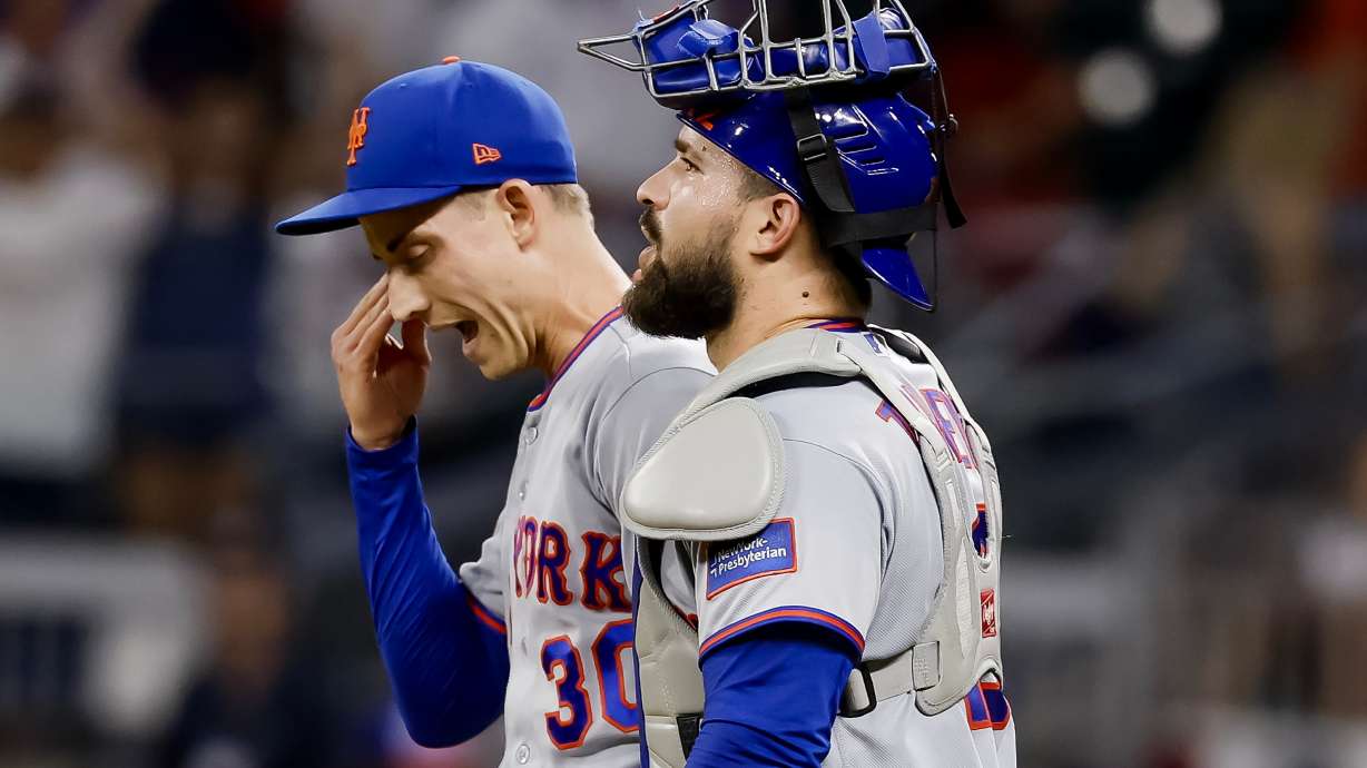 New York Mets pitcher Luke Weaver, left, reacts with catcher Luis Torrens, right, after their team defeated the Atlanta Braves during the 10th inning of a baseball game, Monday, July 6, 2026, in Atlanta.