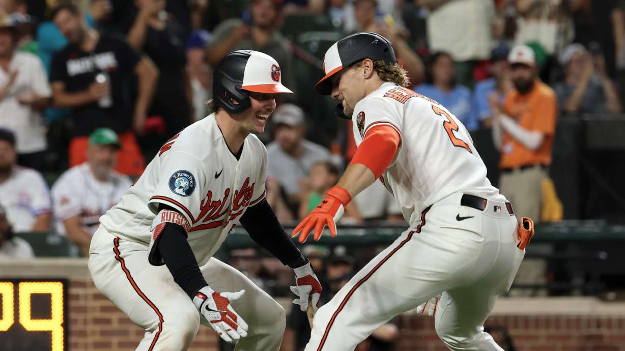Baltimore Orioles' Gunnar Henderson (2) celebrates with Adley Rutschman, left, after hitting a home run off Kansas City Royals pitcher Eli Morgan during the eighth inning of a baseball game, Saturday, July 11, 2026, in Baltimore.