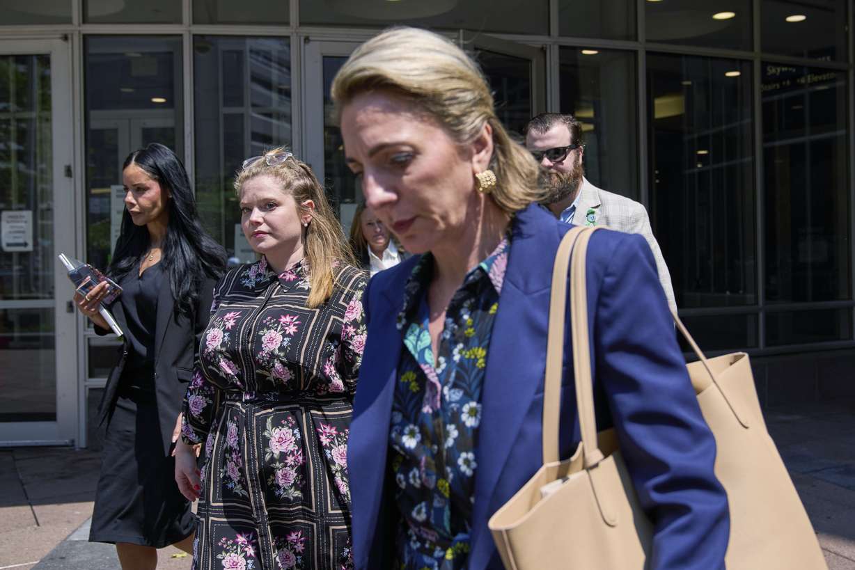 Colin Hortman, behind, son of Melissa and Mark Hortman, and his wife Alina Bachman Hortman, second from left, leave after attending the initial state court appearance for Vance Boelter on Monday in Minneapolis.
