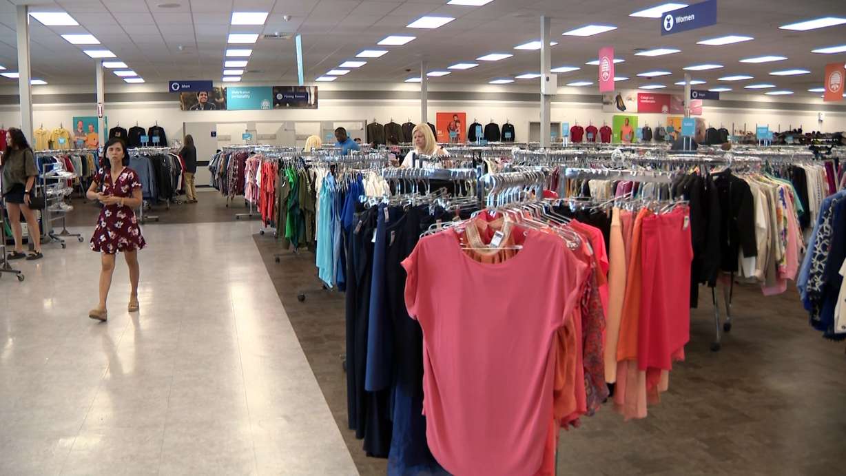 Shoppers move through the clothing aisles at Deseret Industries, which reports increases in both donations and customer traffic.