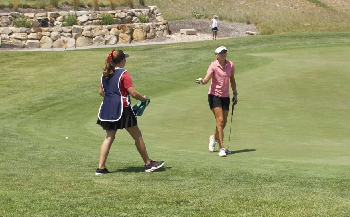 Pro golfer Ali Mulhall hands a ball to her sister during the opening round of the Larry H. Miller Utah Women's Open, Monday, Aug. 3, 2026 at TalonsCove Golf Course in Saratoga Springs, Utah.