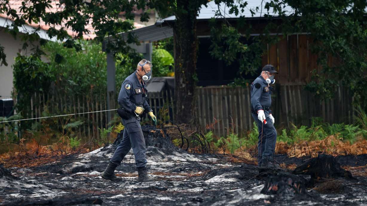 Bomb disposal experts work on a site after the discovery of shells from World War II in a neighborhood of Le Porge on Monday.