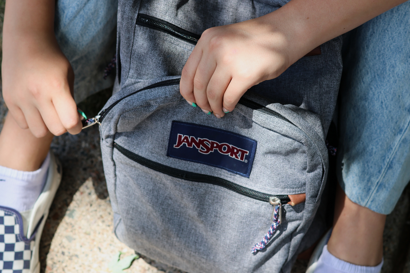 Middle school student Claire Knoth, 13, zips up her backpack after packing it with school supplies Friday in Flagstaff, Ariz.