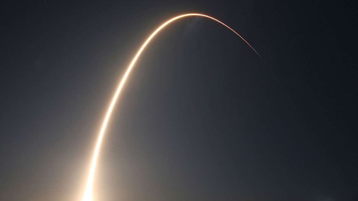 The SpaceX Falcon 9 rocket is seen arcing over the sky after liftoff in 2025.