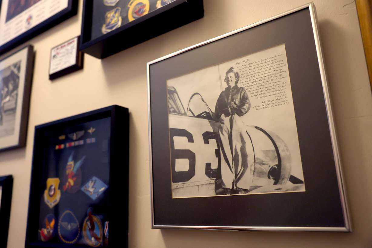 Photographs and mementos belonging to Nell “Mickey” Stevenson Bright hang in the living room of her home in Salt Lake City on July 15. Stevenson is the last living female pilot who served in World War II.